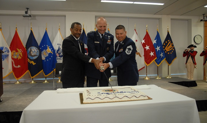 Dr. Jonathan Woodson, assistant secretary of Defense for Health Affairs (left), Air Force Lt. Gen. Douglas Robb, DHA director, and Air Force Chief Master Sgt. Edward Vottero, interim DHA senior enlisted advisor cut the cake during the celebration marking the agency's achievement of full operating capability. The DHA was awarded the Joint Meritorious Unit Award from Secretary of Defense Ashton B. Carter for exceptionally meritorious achievements since Oct. 1, 2013. (DoD photo by Kevin Dwyer)