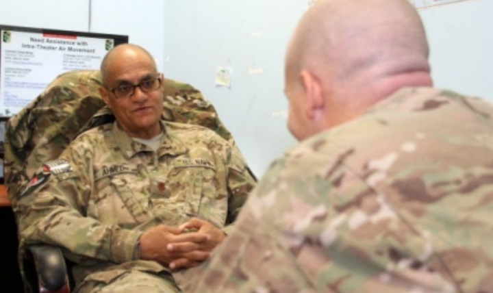 Lt. Cmdr. Mahmoud Ahmed, a Navy psychiatrist, left, speaks with a patient at the NATO Role 3 Multinational Medical Unit on Kandahar Airfield, Afghanistan. U.S. Navy photo by Lt. Cmdr. Jesse Ehrenfeld