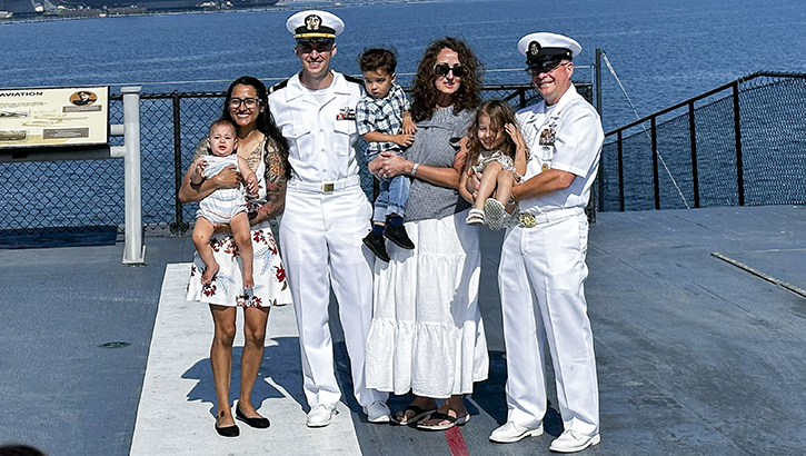 From left to right: Kelcy Pryor, Ensign Timothy Pryor, assigned to 1st Medical Battalion, Juanita Pryor, mother of Timothy Pryor, and U.S. Navy Command Master Chief Zachary Pryor, command master chief of Naval Medical Forces Atlantic, pose for a group photo during a commissioning ceremony on the flight deck of the USS Midway Museum on July 11, 2023.  (Photo: U.S. Navy Lt. Corey Smith) 