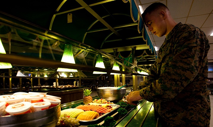 Marine Lance Cpl. Alex Bosma, a native of Seattle, grabs a plate of fruit. More and more restaurants offer fruit or salads as entrees, which is a great way to increase your fruits and vegetable intake. (U.S. Marine Corps photo by Cpl. James Sauter)