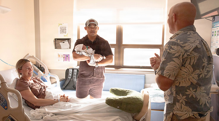  Col. William Bimson, commander of Tripler Army Medical Center, presented a gift basket to U.S. Army Capt. Henry Zenger and Capt. Cecilia Zenger following the birth of their son, Gus Zenger