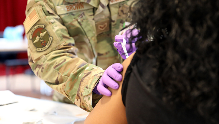 Image of A person getting an injection on their arm.
