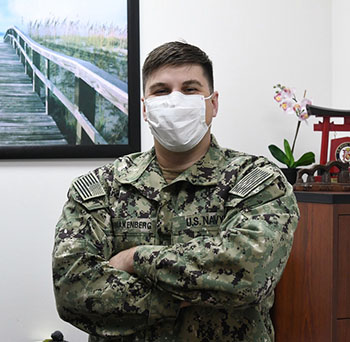 A naval doctor poses for a photo.