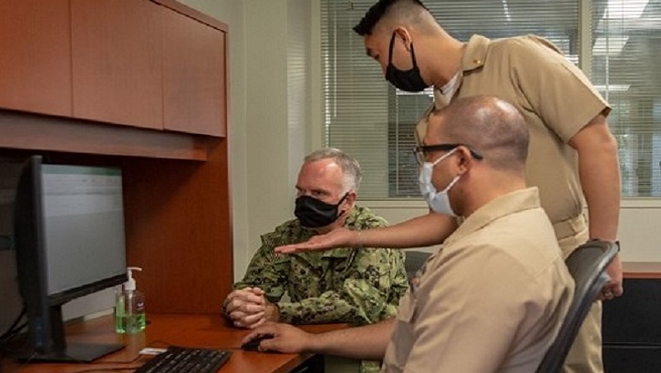 Image of three military personnel, wearing masks, in front of a computer screen. Click to open a larger version of the image. Click to open a larger version of the image.