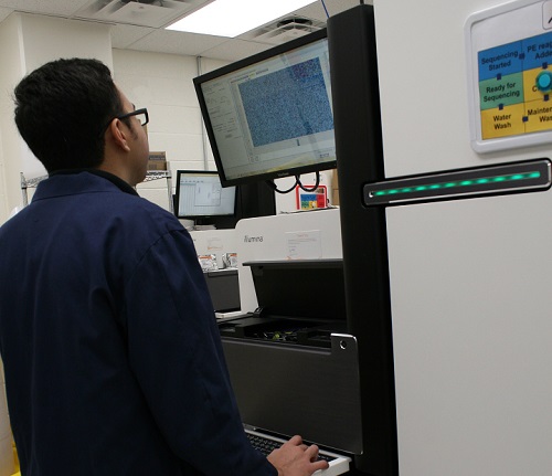 Nathan Watt, a research associate at the Uniformed Services University of the Health Sciences, closely monitors data on a next-generation sequencer in The American Genome Center at the university. (DoD photo by Sarah Marshall)