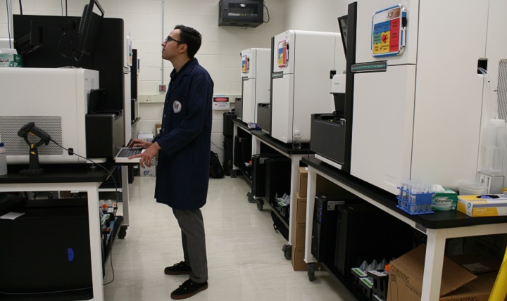 Nathan Watt, a research associate at the Uniformed Services University of the Health Sciences, closely monitors data on a next-generation sequencer in The American Genome Center at the university. This sequencing helps pinpoint genetic mutations that could serve as biomarkers, which can better predict disease risks and outcomes. TAGC is one of four academic genome centers in the U.S. and the only genome center in the federal system.  (DoD photo by Sarah Marshall)