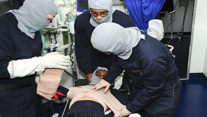 Sailors treat a patient with simulated chest and arm wounds during a general quarters drill aboard the aircraft carrier USS George Washington. (U.S. Navy photo by Mass Communication Specialist Seaman Kashif Basharat)