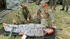 U.S. Navy Hospitalman Jeremy Tayaban, from Expeditionary Medical Facility Kilo (right), and a 4th Medical Battalion Sailor perform a Tactical Combat Casualty Care assessment on a notional patient to ascertain triage category during exercise Global Medic 24.