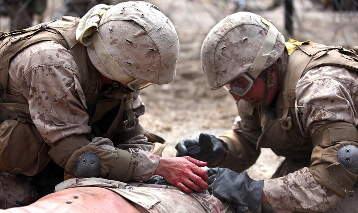 Navy corpsmen with Field Medical Training Battalion West apply first aid to a training dummy during a training exercise in Camp Pendleton, Calif. The corpsmen learn to apply first aid in combat and work with Marine units. (U.S. Marine photo by Lance Cpl. Joshua Young)