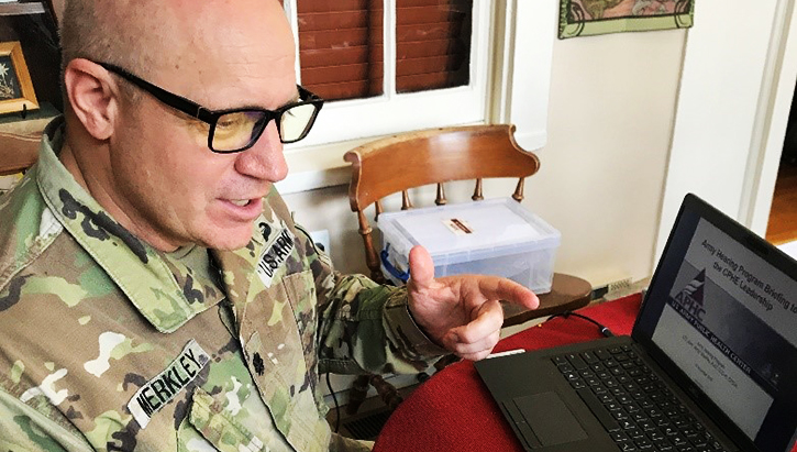 Image of Military personnel sitting in front of laptop. Click to open a larger version of the image.
