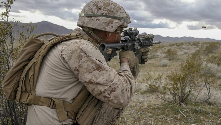 Image of Marine holding and aiming a rifle. Click to open a larger version of the image.