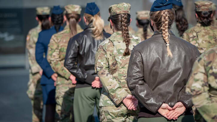 Female Airmen stand at attention.