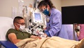 a nurse helping a COVID-19 patient