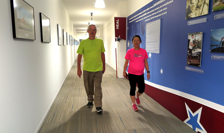 Frank Rowland and Siwei Luo from the Health Information Technology Directorate, Defense Health Agency, arrive early before their work day begins and use the DHHQ indoor walking trail to maintain their fitness goals of walking 10,000 steps per day.