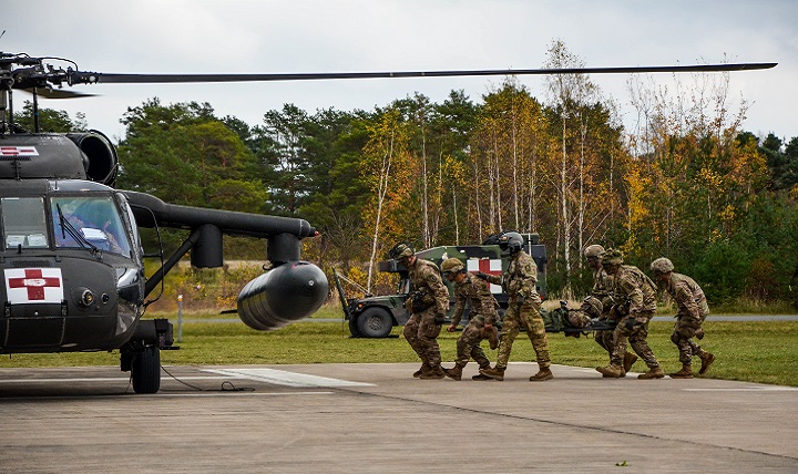 Medics from the 173rd Airborne Brigade load a patient who received treatment at the battalion aide station onto a MEDEVAC helicopter from C/1-214 Aviation Brigade at Grafenwohr, Germany. (U.S. Army photo by Lt. Col. John Hall)