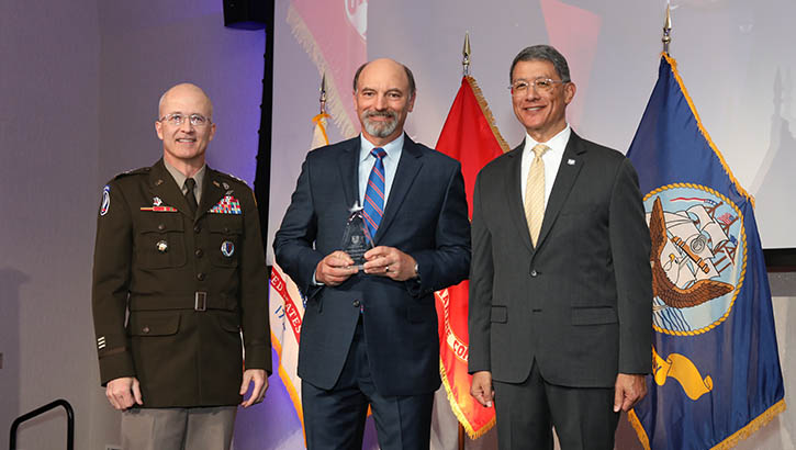 Army Lt. Gen. (Dr.) Ron Place, Dr. Michael Helwig and Joseph Caravalho, Jr. posing for the photo
