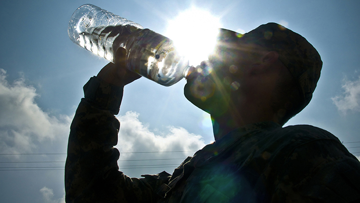 Soldier drinking from a water bottle
