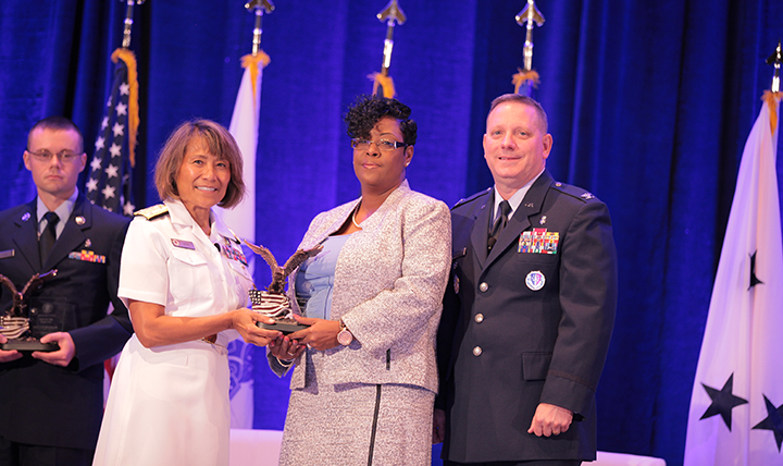 Vice Admiral Raquel C. Bono, director of the Defense Health Agency, presents the DHA/J-6 Category II Civilian of the Year Award to Ms. Cynthia Amires at the Defense Health Information Technology Symposium on July 25, 2017 in Orlando, Florida.