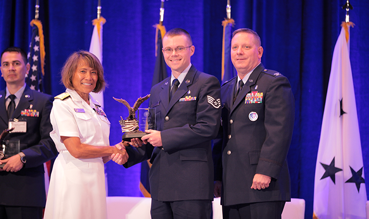 Vice Admiral Raquel C. Bono, director of the Defense Health Agency, presents the DHA/J-6 NCO of the Year Award to Staff Sergeant Steven Edgar at the Defense Health Information Technology Symposium on July 25, 2017 in Orlando, Florida.
