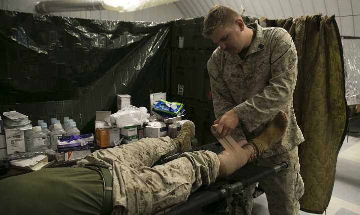 Navy Petty Officer Third Class Alexander Iwan, a corpsman with the 8th Regimental Aid Station, provides aid to a patient during Integrated Training Exercise 1-16 at Marine Air Ground Combat Center, Twentynine Palms, Calif. The 8th Regimental Aid Station provides medical care to Marines as needed during ITX while also demonstrating their abilities to operate in a field environment. (U.S. Marine Corps photo by Sgt. Tia Nagle)