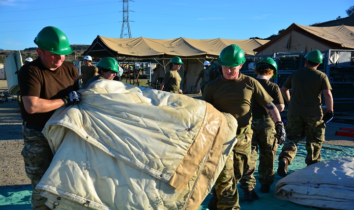 Soldiers from the United Kingdom's Second Medical Brigade disassemble an expeditionary medical facility as part of Operation Integrated Serpent, a joint, bilateral training exercise between the U.S. Navy and the British Army.  