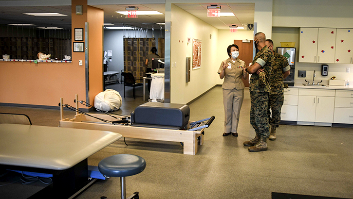 U.S. Navy Commander Diana Fu explains the physical therapy room at Intrepid Spirit Concussion Recovery Clinic to Marine Corps Installations East Commander on Aug. 2, 2021. (Photo by Naval Medical Center Camp Lejeune)
