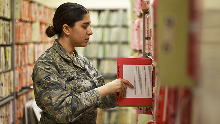 Image of soldier putting away a paper file