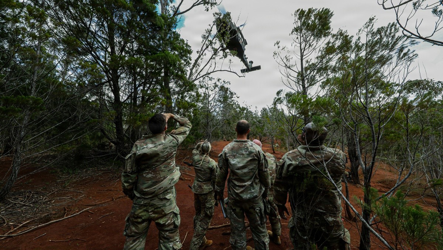 Senior U.S. Army medical leaders and Soldiers observe an air medical evacuation aircraft conduct jungle extraction operations during jungle medicine training