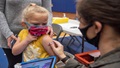 Child wearing a mask getting the COVID-19 vaccine