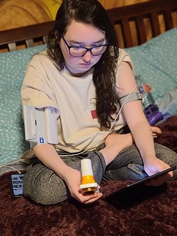 Image of woman looking at contents of a home health kit