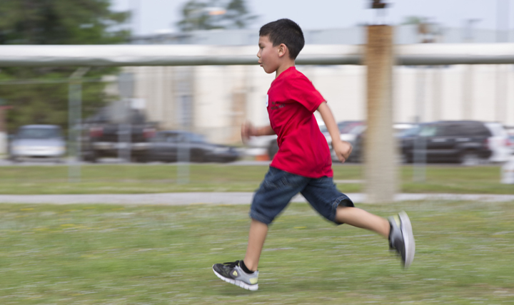 Christian Macias runs in a combat fitness test modified for children at a “bring your child to work day” event at Marine Corps Air Station Cherry Point, North Carolina. (U.S. Marine Corp photo by Sgt. N.W. Huertas) 