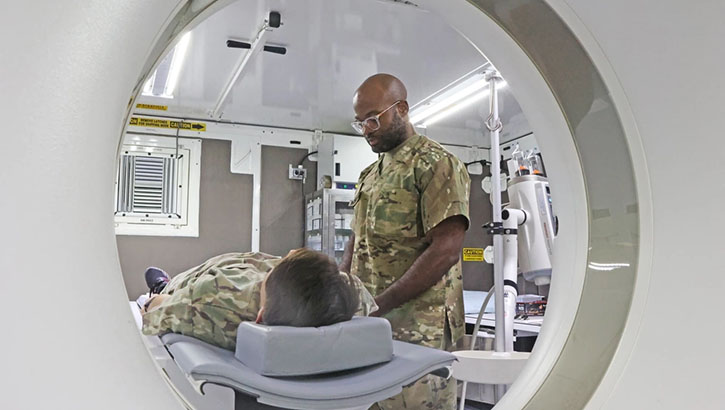 U.S. Maj. Remy Ngwanyam, a radiologist with the 528th Hospital Center, demonstrates using the new 128-slide computed tomography scan at Camp Arifjan, Kuwait, on Dec. 11, 2023. The upgraded CT scan will greatly improve patient care with its reliability and advanced features. (Photo by U.S. Staff Sgt. Brina Jenkins, 1st Theater Sustainment Command)