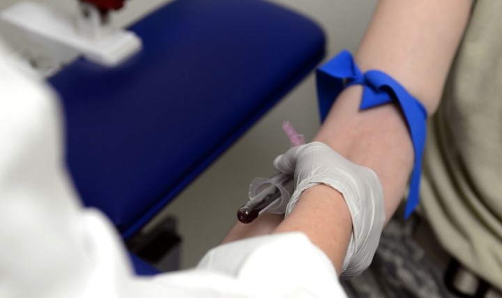 U.S. Air Force Tech. Sgt. Kristi Jordan, 97th Medical Support Squadron NCO in charge of laboratory service, draws blood from a patient at the laboratory, Jan. 13, 2015. There are a variety of samples collected at the laboratory to determine whether an individual is healthy or not, such as blood, urine or sweat sample tests. (U.S. Air Force photo by Senior Airman Franklin R. Ramos/Released)
