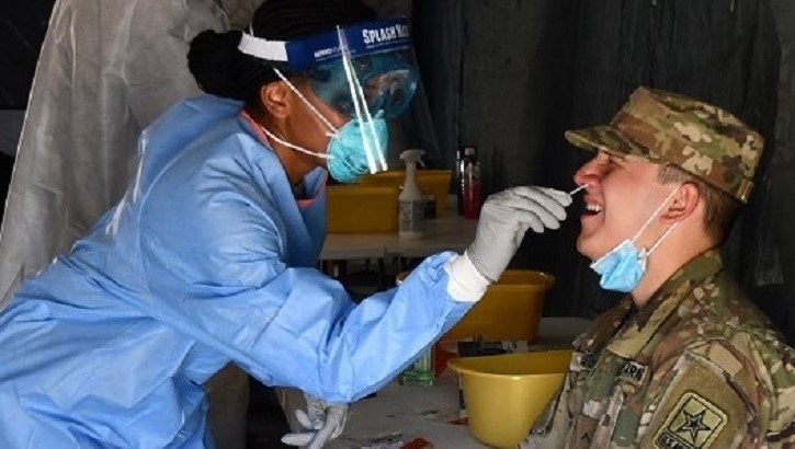 Image of Army soldier gets nose swab. Click to open a larger version of the image.