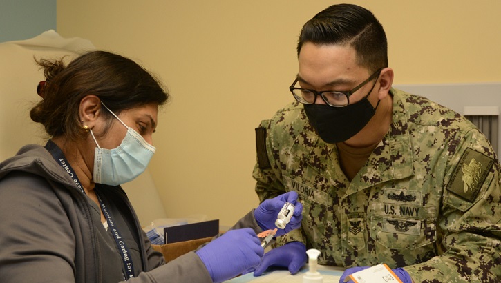 Military health personnel preparing to administer the COVID-19 vaccine