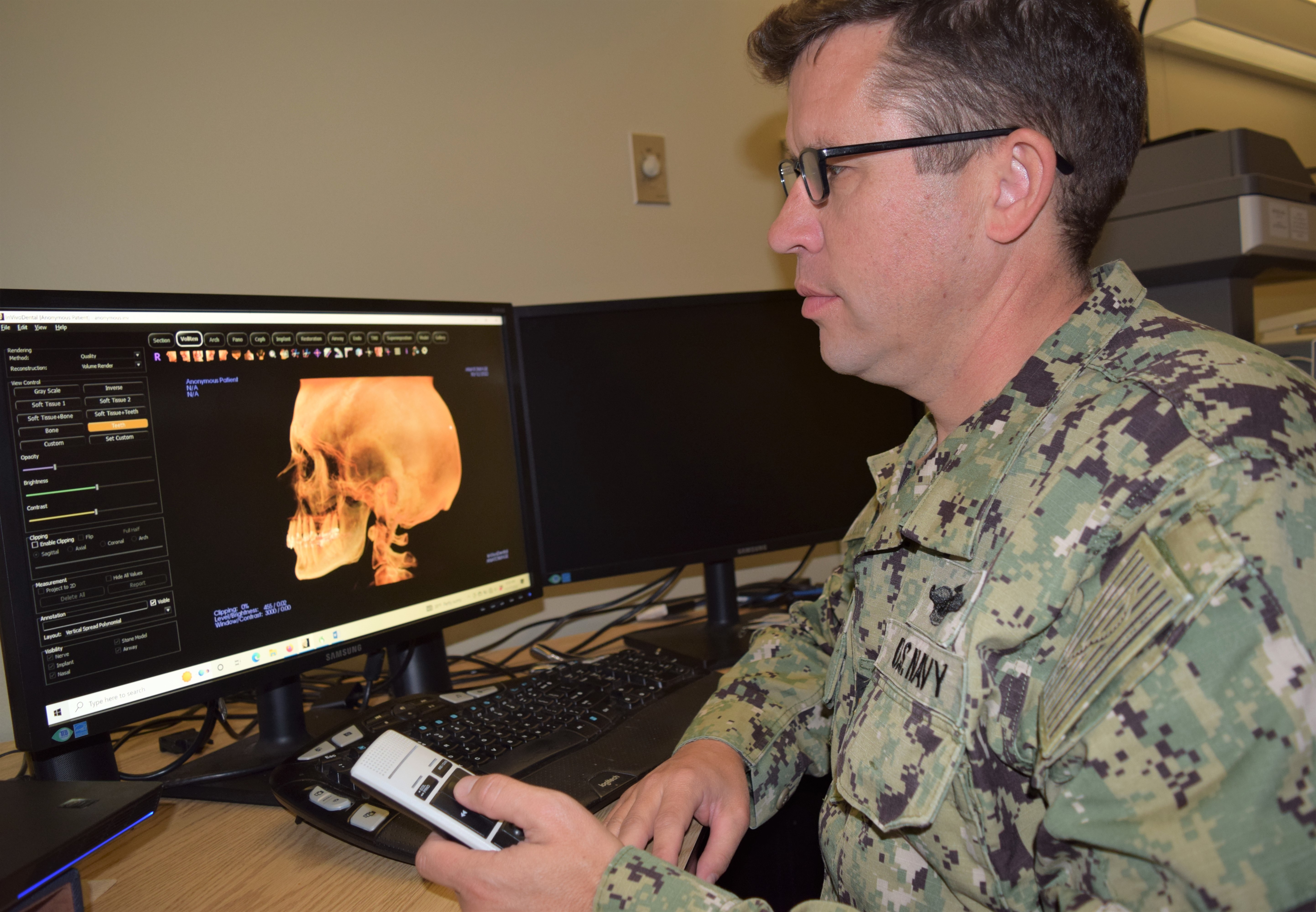 Image of Computer screen with doctor examining image.