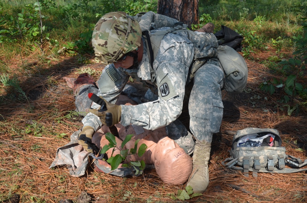 A soldier applies a tourniquet to a simulated casualty during a training exercise. (Courtesy photo)