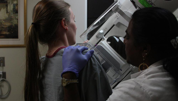 lead mammographer performing a mammogram