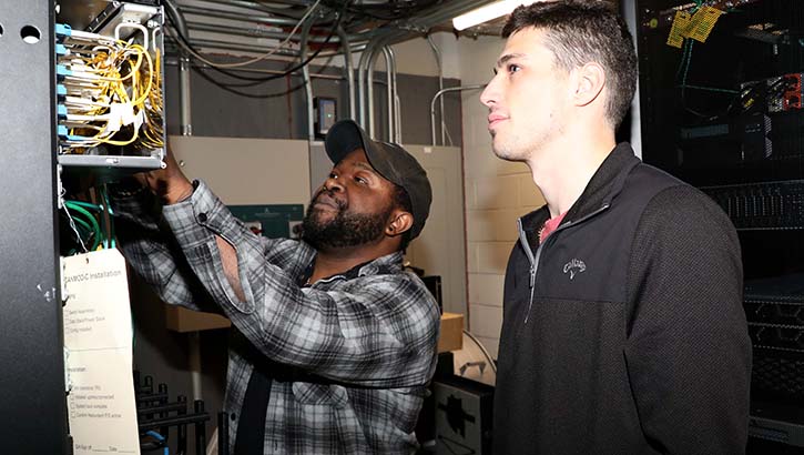 Kevin Harris (left) and Sheldon Bush, both information technology specialists with the Guthrie Army Health Clinic’s Information Management Division, conduct a check of a server