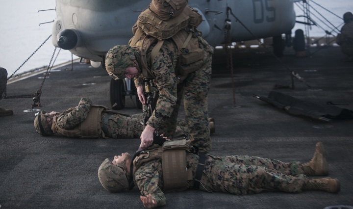 A Sailor with Combat Logistics Battalion 15, 15th Marine Expeditionary Unit, tends to a simulated causality during a mass-casualty drill on the flight deck of the USS Essex. The Marines and Sailors honed their skills to become quicker and more efficient should a situation arise where medical attention is needed. The 15th MEU is currently deployed in the Indo-Asia-Pacific region to promote regional stability and security in the U.S. 7th Fleet area of operations. (U.S. Marine Corps photo by Cpl. Elize McKelvey)