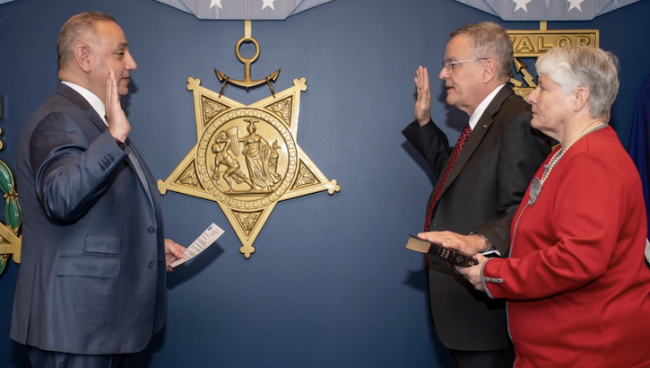 Dr. Lester Martinez-López is sworn in as the new assistant secretary of defense for health affairs by Gilbert R. Cisneros, the undersecretary of defense for personnel and readiness, at the Pentagon on March 21. Holding the Bible for his oath of office is Martinez-López’s wife, Lydia Martinez. 