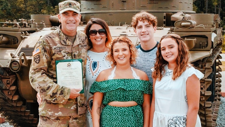 Image of McGrath in uniform with his family. Click to open a larger version of the image.