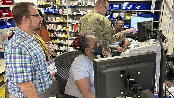 Pharmacy staff at Kimbrough Ambulatory Care Center receive on-site support from individuals identified as an MHS GENESIS “Super User” or individuals from previous launches who are help train staff during the transition to MHS GENESIS at Kimbrough, at Fort Meade, Maryland. (Photo: Michelle Gonzalez, Defense Health Agency)