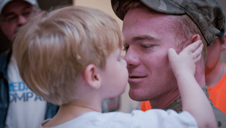 A child holding his dad's face