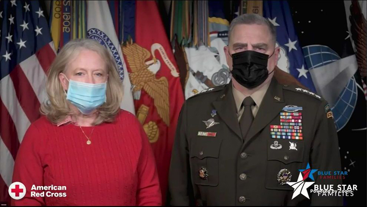 Image of Mr. and Mrs. Milley, wearing masks, standing in front of various flags. Click to open a larger version of the image.
