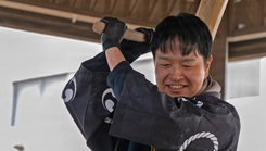 Dr. Akimasa Takahashi, a Japanese Fellow assigned to U.S. Naval Hospital Yokosuka, uses a kine (mallet) to pound rice during a traditional mochitsuki ceremony at the hospital.
