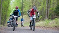 People biking on a trail in protective gear