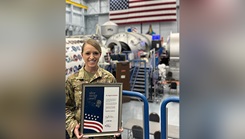 U.S. Air Force Lt. Col. Danielle Anderson poses with her Silver Snoopy Award at the space vehicle mockup facility located within NASA’s Johnson Space Center, Houston, Texas, Sept. 20, 2024. Since September 2021, Anderson has led the musculoskeletal medicine and rehabilitation team for Space Medicine Operations at Johnson Space Center. (Photo by U.S. Air Force Lt. Col. Danielle Anderson)