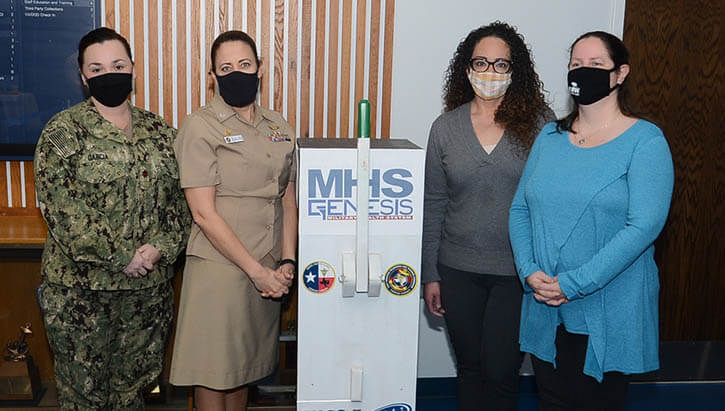 Navy Capt. Jessica Bain, NHC Corpus Christi commanding officer, is joined by Lt. Cmdr. Angelica Garcia, MHS GENESIS site lead, Amber Medina, site integration manager, and Colleen Rock, program integration analyst, to ceremoniously flip the switch, celebrating the full integration of MHS GENESIS, the next-generation electronic health record system , which was launched at the clinic on Jan. 22