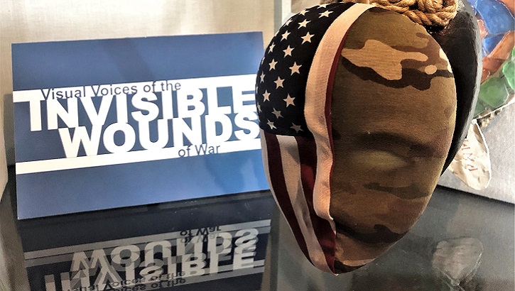 Image of Picture of a mask with the American flag on one side and camo on the other side. Click to open a larger version of the image.